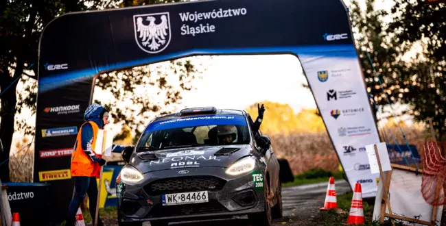 Safeciarz (sędzia zabezpieczenia) odbierający kartę drogową od pilota na mecie stop w Rajdzie Śląska 2024